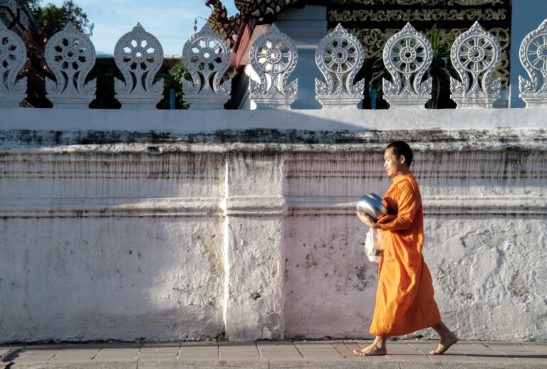 man walking beside wall